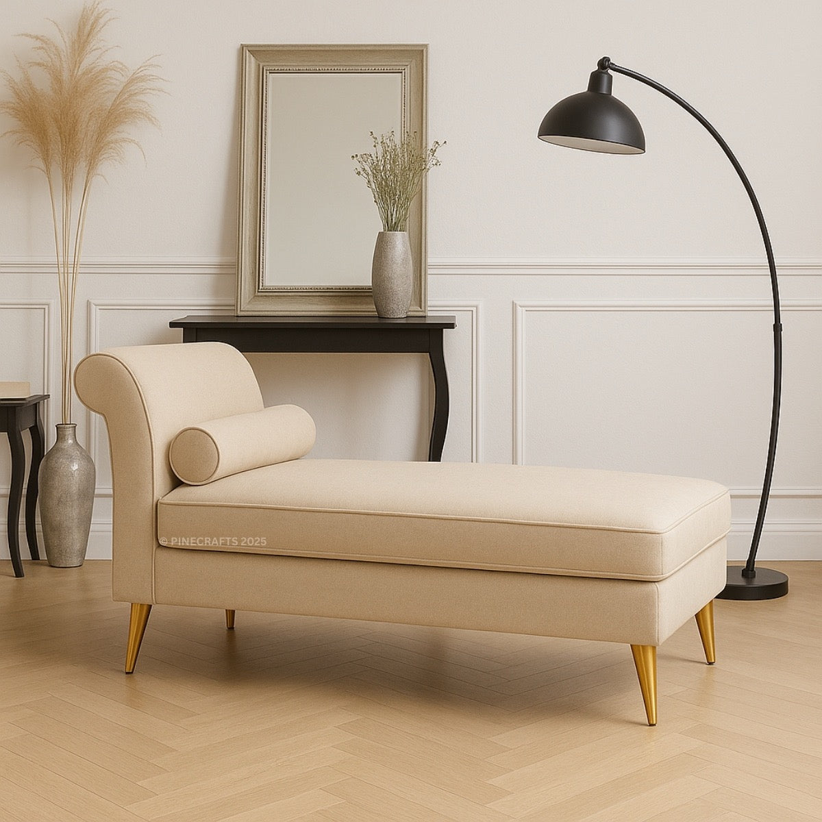 Beige chaise lounge in a stylish room with a lamp and mirror.
